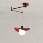 LED terracotta table chandelier, retractable with folding arm. Composed of a large white lit ball, a kind of leatherette circle placed on top and held by a ball through which passes the cable that holds the luminaire. On a gray background.