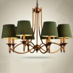Bronze chandelier with eight green fabric shades. Candelabra shape on a light gray background.