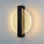 Modern wall light in iron and acrylic on grey background