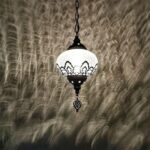 a Moroccan-style chandelier in black and white against a dark grey background