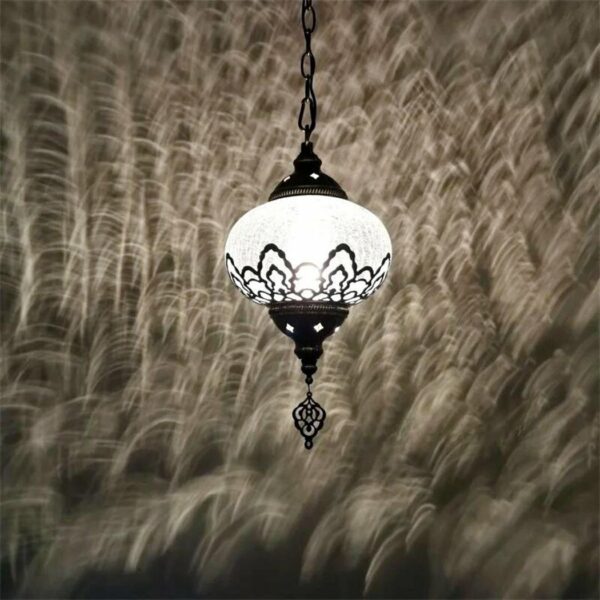 a Moroccan-style chandelier in black and white against a dark grey background