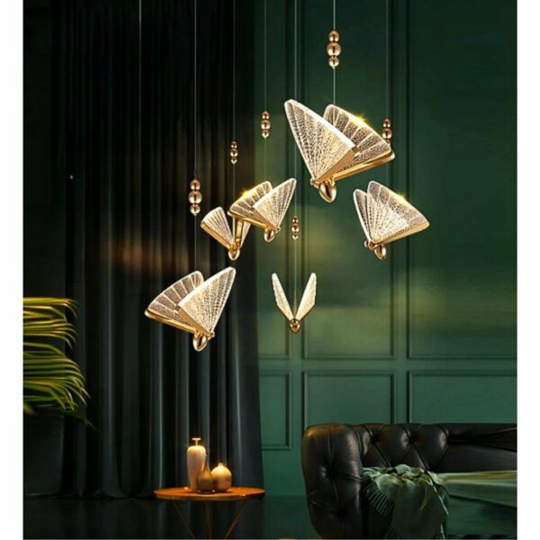 in a dark brown-green living room, we see a golden, transparent butterfly-shaped hanging lamp