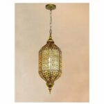a luxurious Moroccan-style chandelier in annealed iron can be seen against a pale violet-pink background