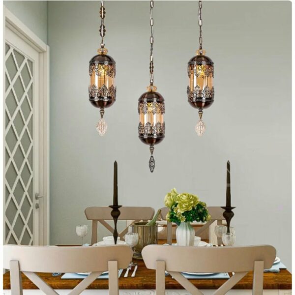 in a dining room, above a table, we see a glass suspension with black motifs in the Moroccan style