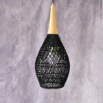 Classic, hand-woven bamboo chandelier in black with a mauve background.