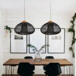 Traditional hand-woven bamboo bedroom chandelier in black, suspended over a dining table.