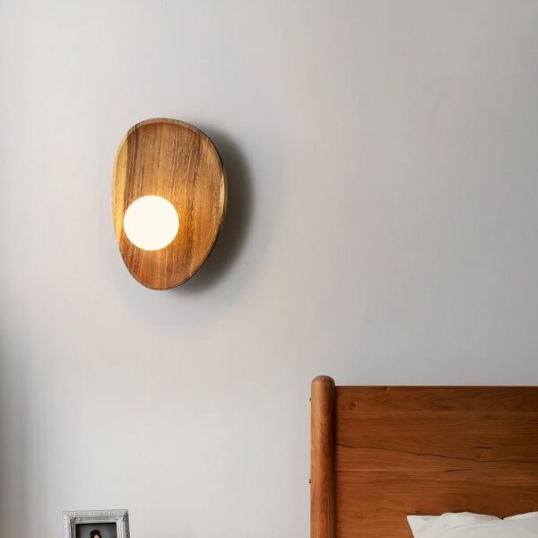 Wooden wall sconce in shell style with small pearl light for hanging on a bedroom wall next to the bed.